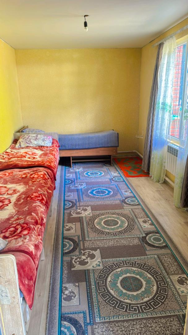 Photo of a shared room with three beds
